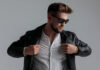 cool dramatic guy wearing leather jacket and sunglasses