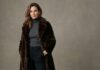 Handsome woman wearing a fur coat in studio, glamorous fashion portrait, elegant winter style, confident expression, refined modern beauty, clean copy space, neutral unbranded setting, natural colors,