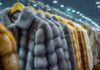 Luxury fur coats hanging in a row on display in a boutique
